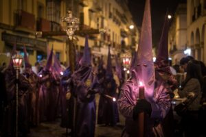 The crowd in costumes in Semana Santa Festival captured in Seville, Spain